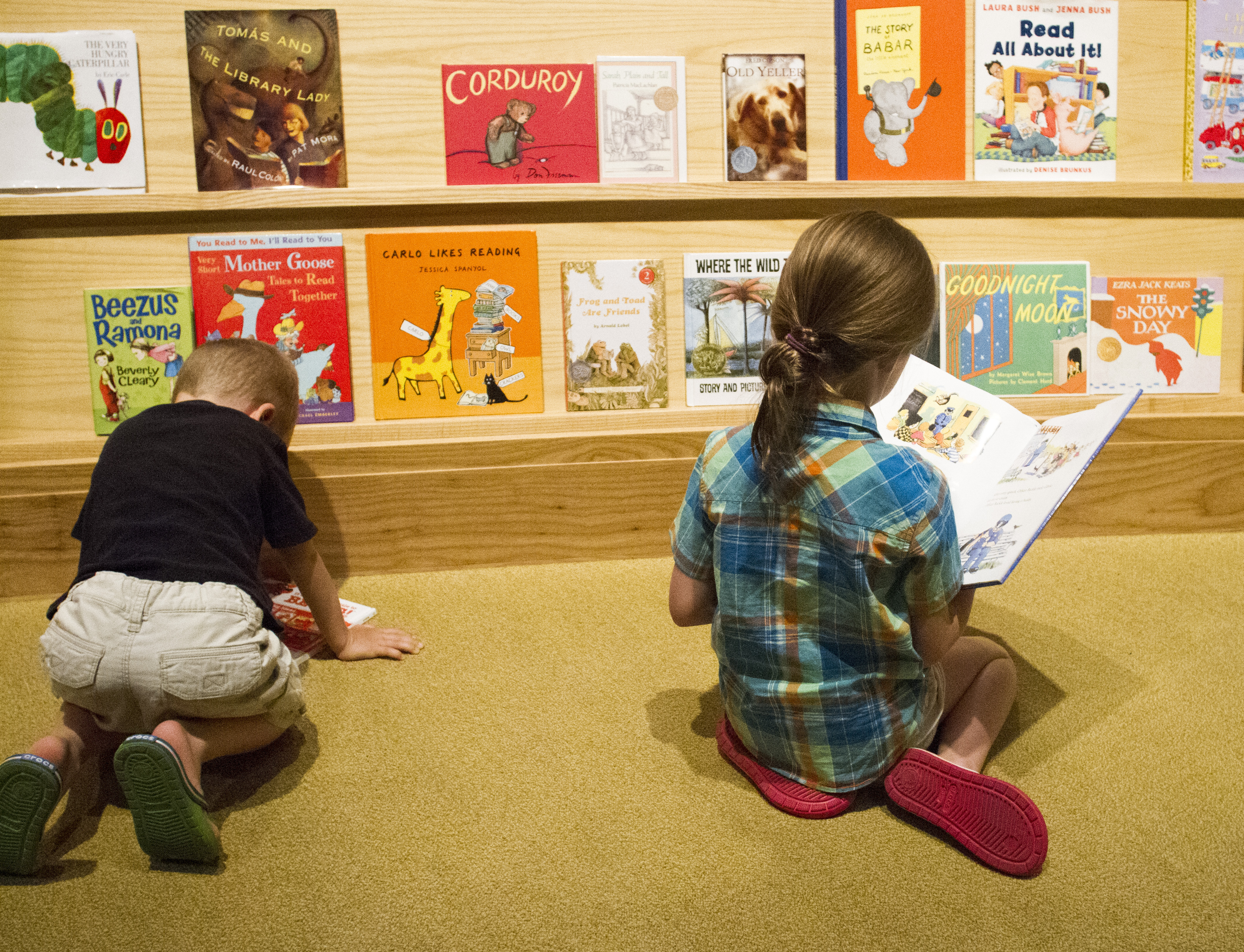 Two young children enjoying the reading area in the No Child Left Behind area of the George W Bush museum