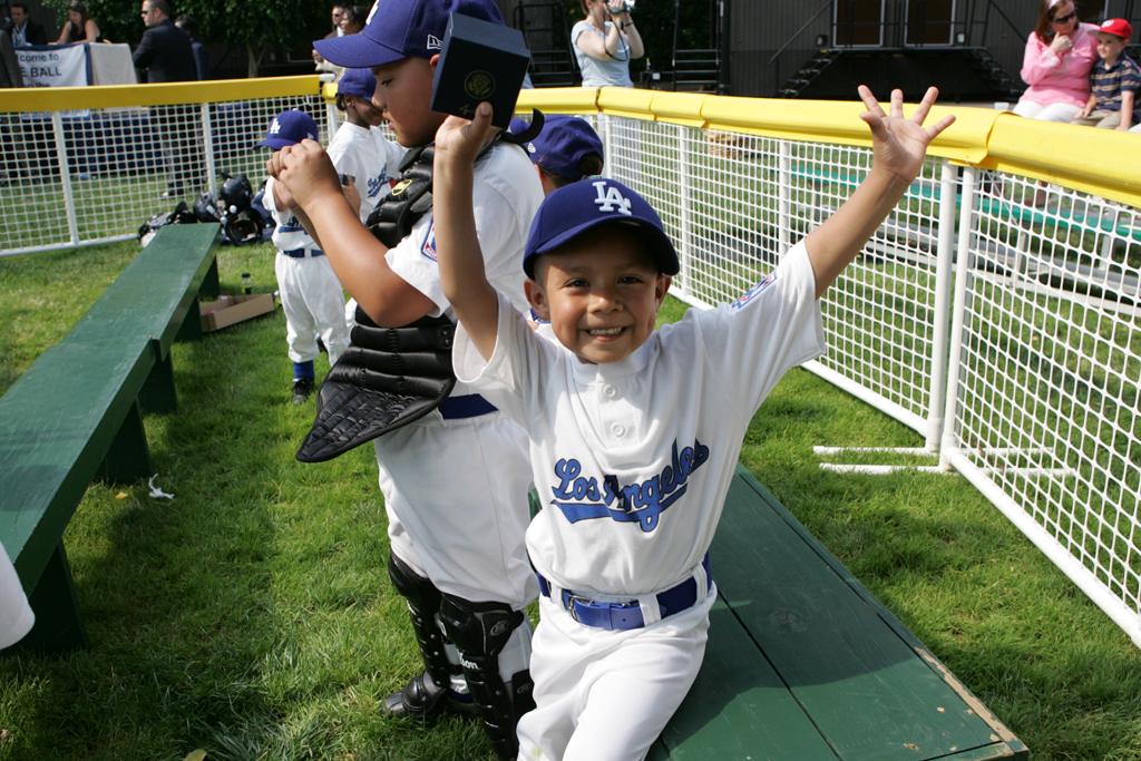 An excited member of the Wrigley Little League Dodgers of Los Angeles shows off his Presidential autographed baseball (P071507JB-0240)