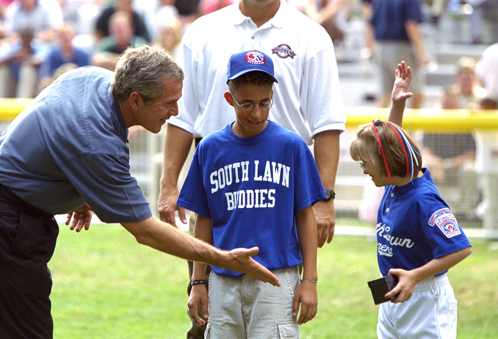 President George W. Bush high-fives players during a tee ball game
