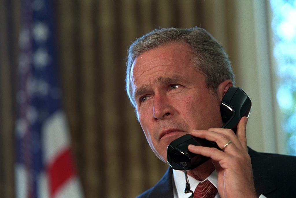 Pledging support for New York, President George Bush talks with Governor George Pataki and New York City Mayor Rudolph Giuliani, September 13, 2001, in a televised telephone conversation from the Oval Office. (P7267-24)