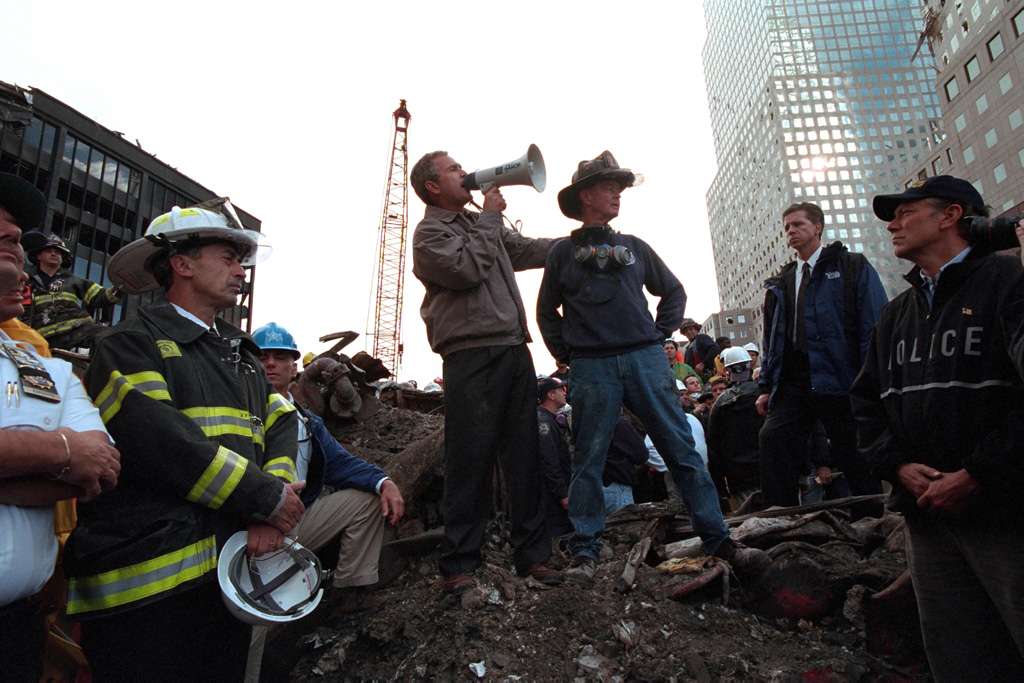 President George W. Bush rallies firefighters and rescue workers, September 14, 2001, during an impromptu speech at the site of the collapsed World Trade Center towers. (P7365-23a)