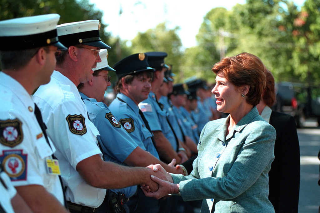 Mrs. Laura Bush greets firefighters and police, September 17, 2001, at a memorial service for victims of United Flight 93 at the Indian Lake Resort in Central City, Pennsylvania. (P7475-05a)