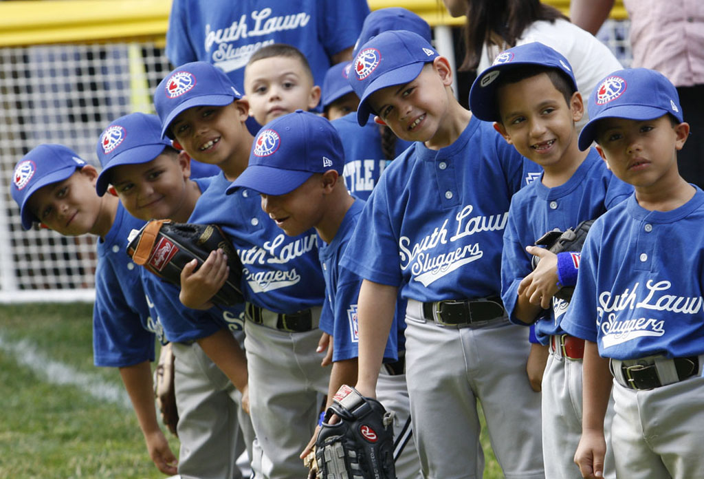 Players of the Jose M. Rodriguez Little League Angels look toward President George W. Bush.