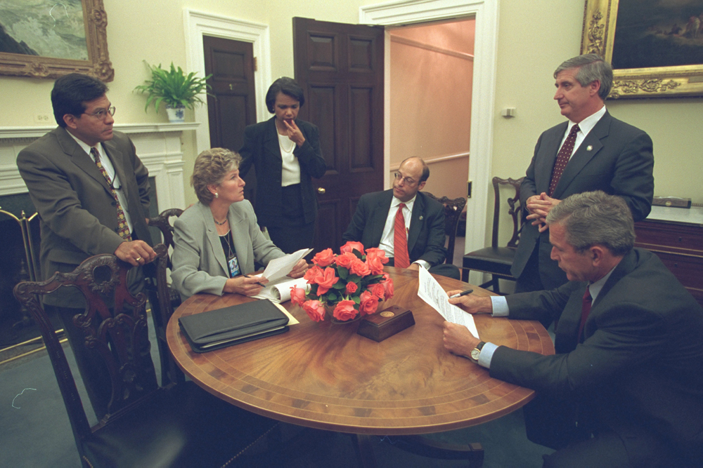 Working with his Senior Staff, President George W. Bush reviews a speech regarding the day's terrorist attacks that he will deliver to the Nation from the Oval Office, September 11, 2001.