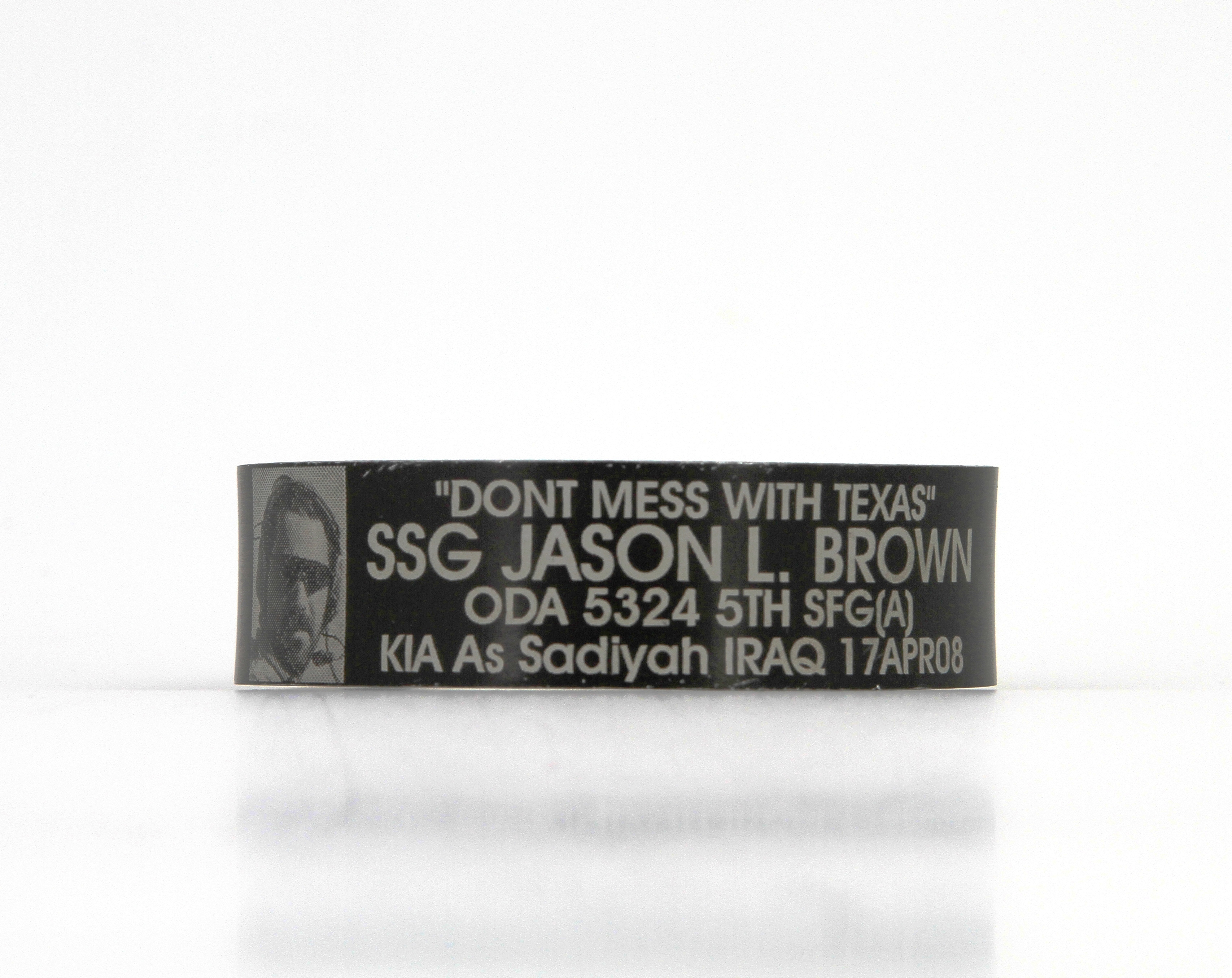 Black metal bracelet engraved with "Don't Mess with Texas - SSG Jason L. Brown - ODA 5324 5th SFG (A) - KIA As Sadiyah Iraq - 17APR08."
