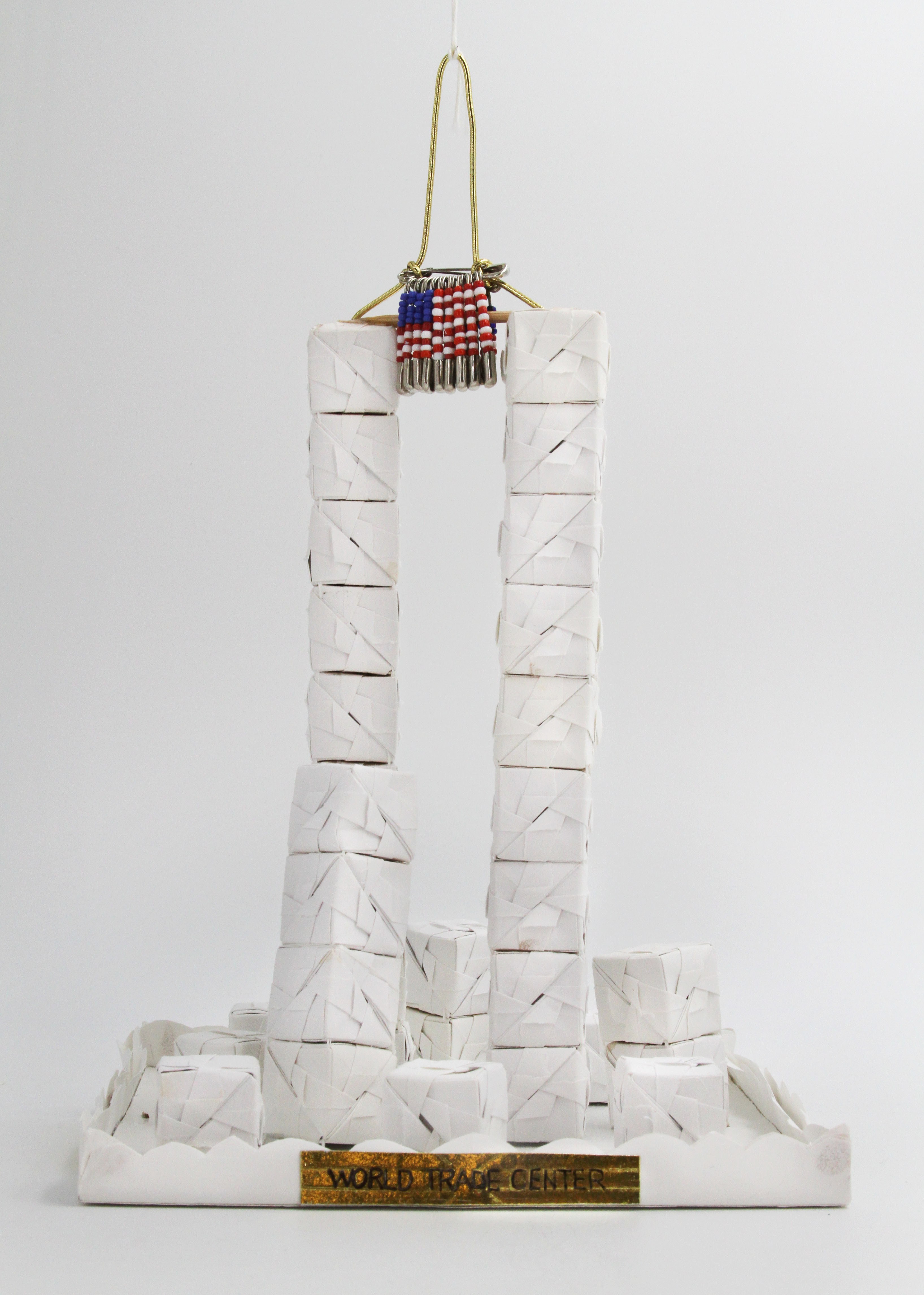 White folded paper blocks forming the World Trade Center twin towers by artist Mei-Kuei Chan Cruise. Originally displayed on the Blue Room Christmas tree in 2001.