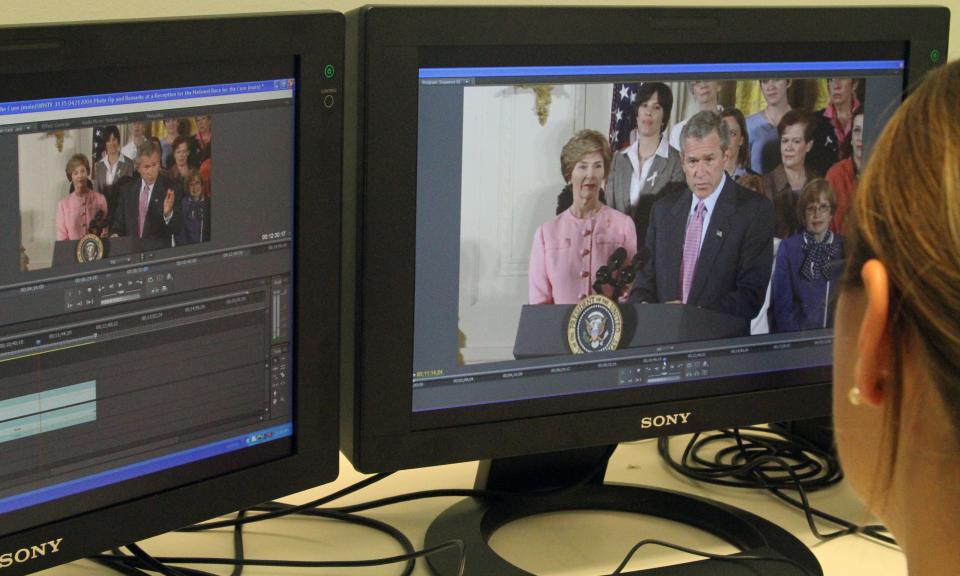An archivist reviews audiovisual materials.