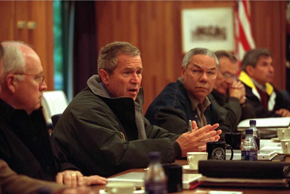 On September 15, 2001,  President George W. Bush confers with his National Security Council at Camp David in Thurmont, Maryland. Pictured from left are: Vice President Dick Cheney; Colin Powell, Secretary of State; Donald Rumsfeld, Secretary of Defense; and Paul Wolfowitz, Deputy Secretary of Defense.