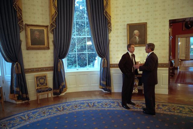 President Bush speaks with Prime Minister Tony Blair in the Blue Room of the White House