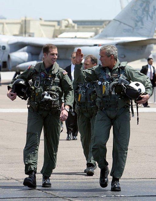  President George W. Bush walks across the tarmac with NFO Lt. Ryan Phillips to Navy One, an S-3B Viking jet, at Naval Air Station North Island in San Diego, May 1, 2003.