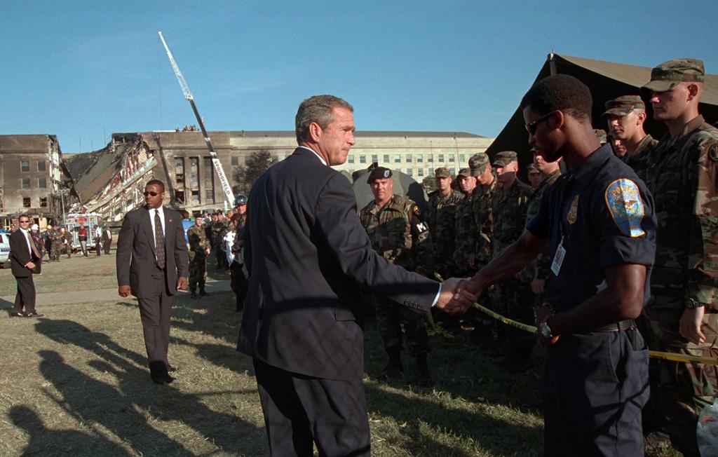 President George W. Bush greets rescue workers, firefighters and military personnel, September 12, 2001, while surveying damage caused by the previous day's terrorist attacks on the Pentagon in Arlington, Virginia. (P7234-21)