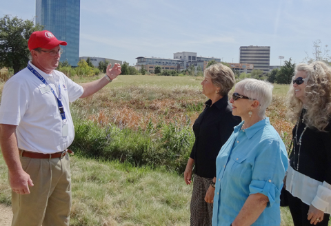 Volunteer gives tour to visitors of grounds 