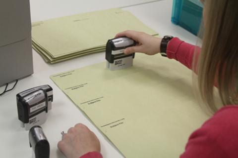 Archivist stamping documents