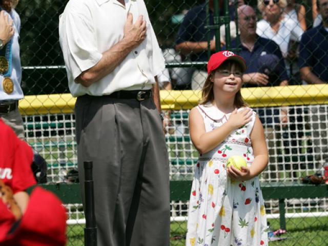 President George W. Bush is joined for the singing of the national anthem by Meredith Cripe.