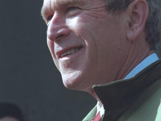 President George W. Bush stands with troops, February 20, 2002, at the U.S. Army Garrison Landing Zone during his trip to Yongsan, Republic of Korea. (P13629-13A)