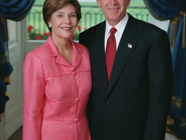 President George W. Bush and Mrs. Laura Bush stand in the Blue Room of the White House for an official portrait, June 4, 2002.