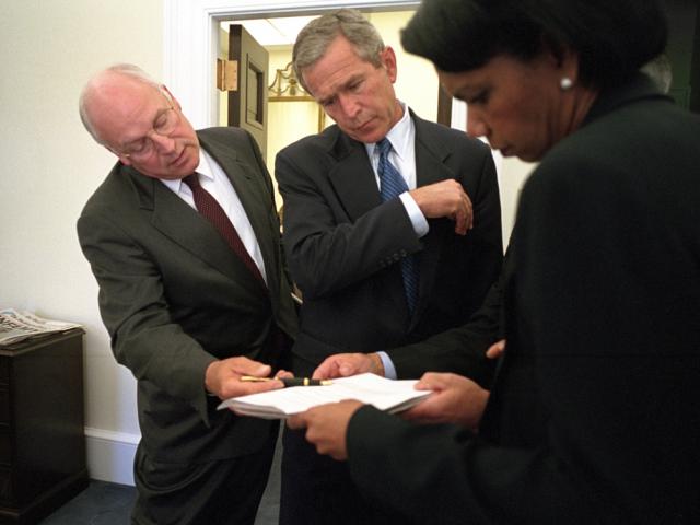 President George W. Bush looks over a briefing paper with Vice President Dick Cheney and National Security Advisor Dr. Condoleezza Rice, September 12, 2001, outside the Oval Office. (P7176-33)