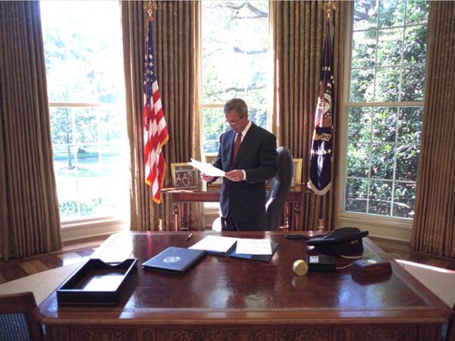 President George W. Bush Reviews a Document in the Oval Office on September 13, 2001.