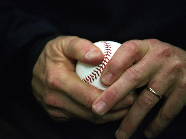 President George W. Bush holds a baseball as he approaches the playing field at Yankee Stadium to throw out the ceremonial first pitch for Game Three of the World Series in New York.