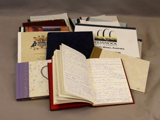 This photograph of a spread of condolence books sent in from Australia illustrates the abundance and variety of books sent in from throughout the world.