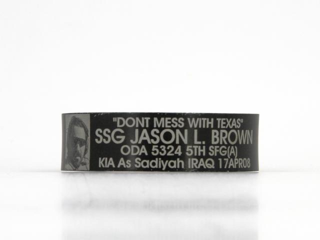 Black metal bracelet engraved with "Don't Mess with Texas - SSG Jason L. Brown - ODA 5324 5th SFG (A) - KIA As Sadiyah Iraq - 17APR08."