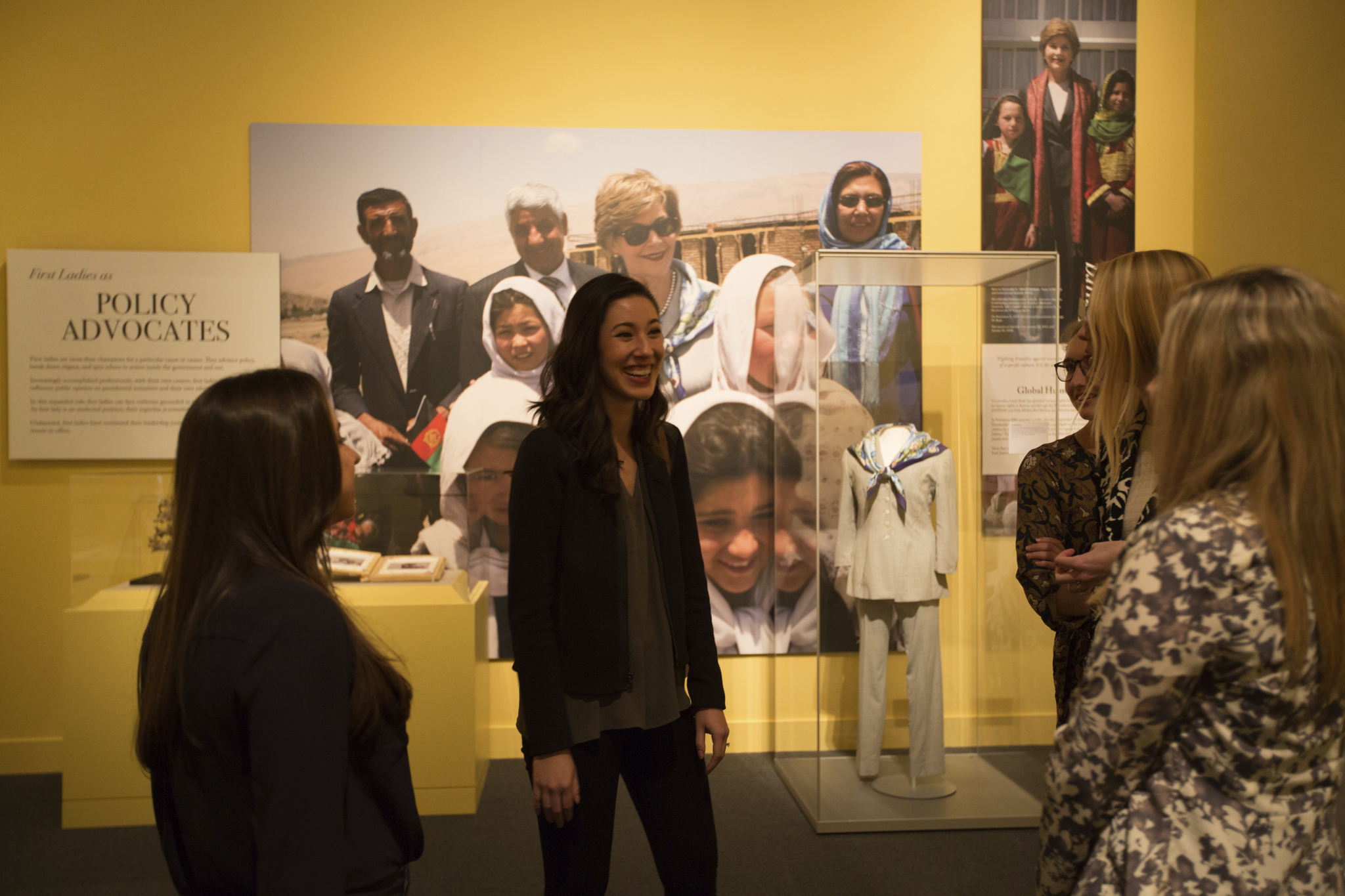 A picture of smiling visitors enjoying the 2018 First Ladies exhibit at the George W Bush Library and Museum