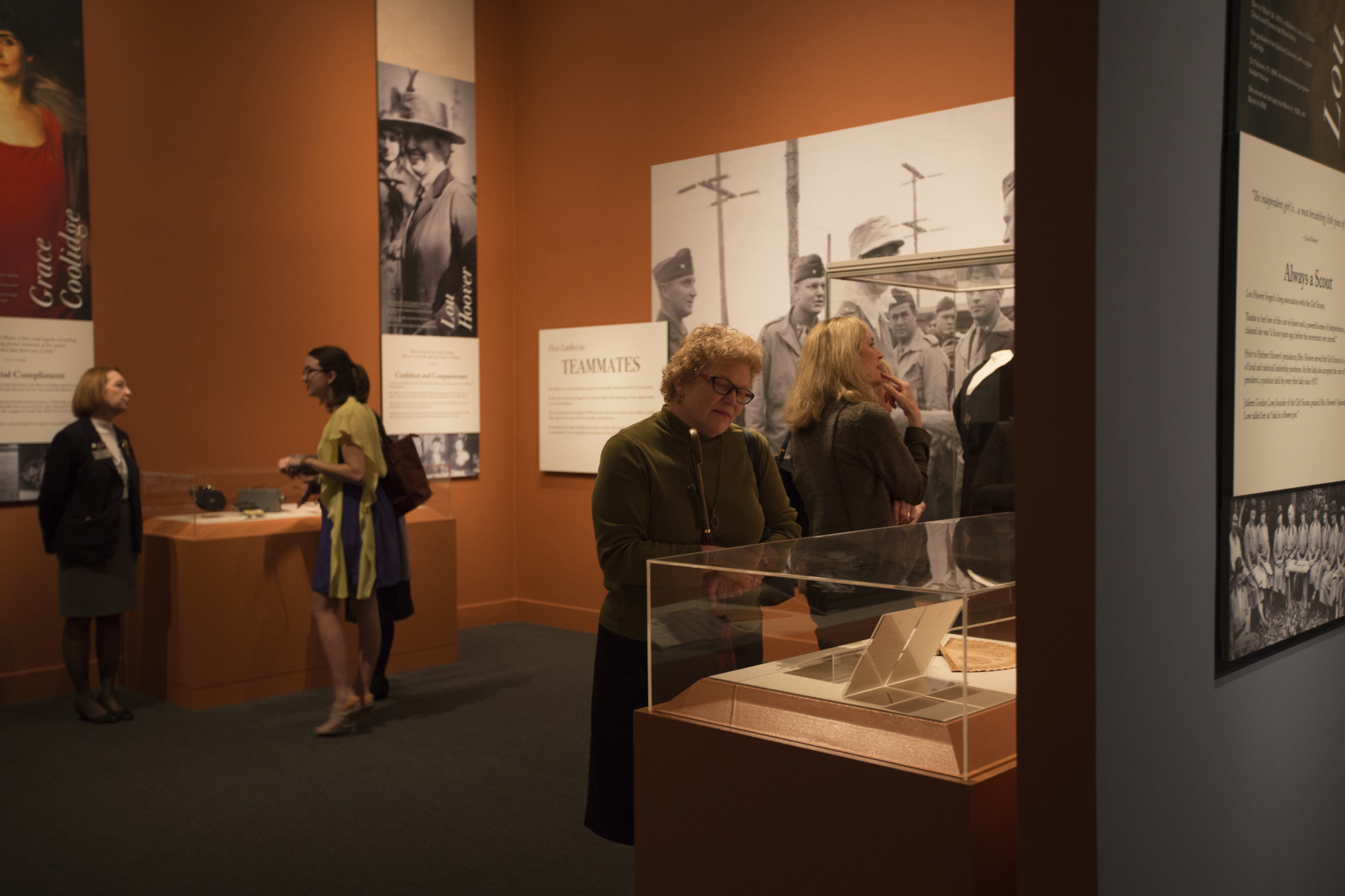 A picture of visitors looking inside display cases from the special exhibit "First Ladies: Style of Influence." 