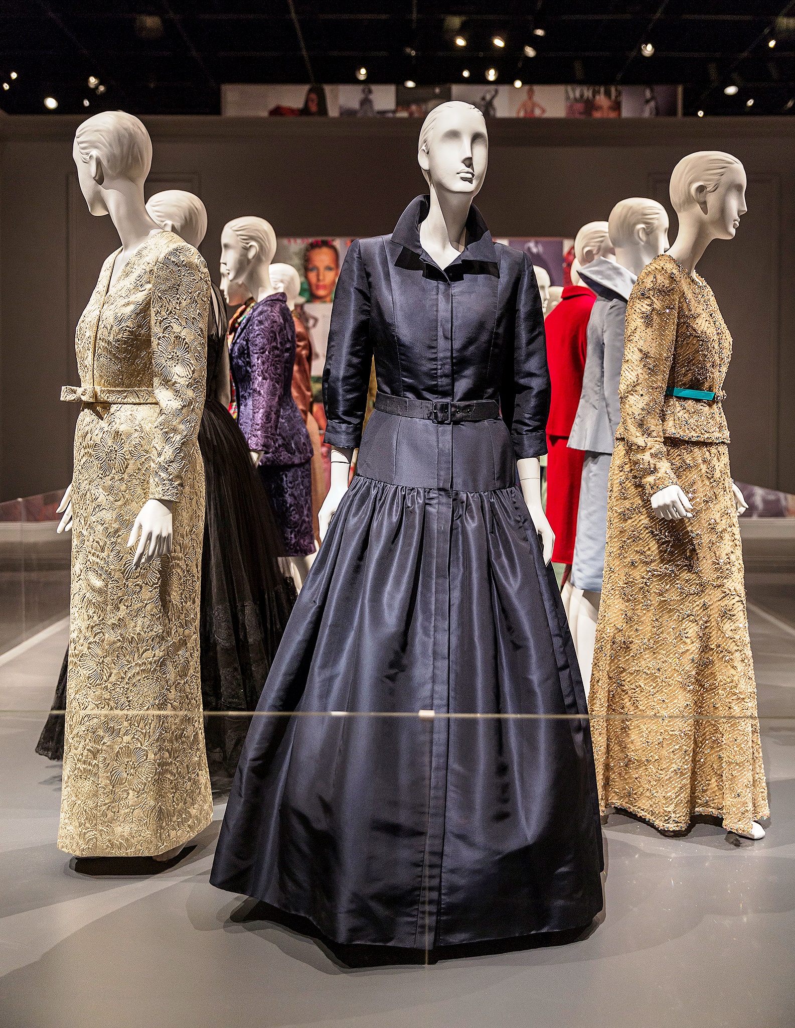 A photo of a display of mannequins wearing formal dresses, part of the 2014 exhibit 'Oscar De La Renta: Five Decades of Style,' at the George W Bush Library and Museum
