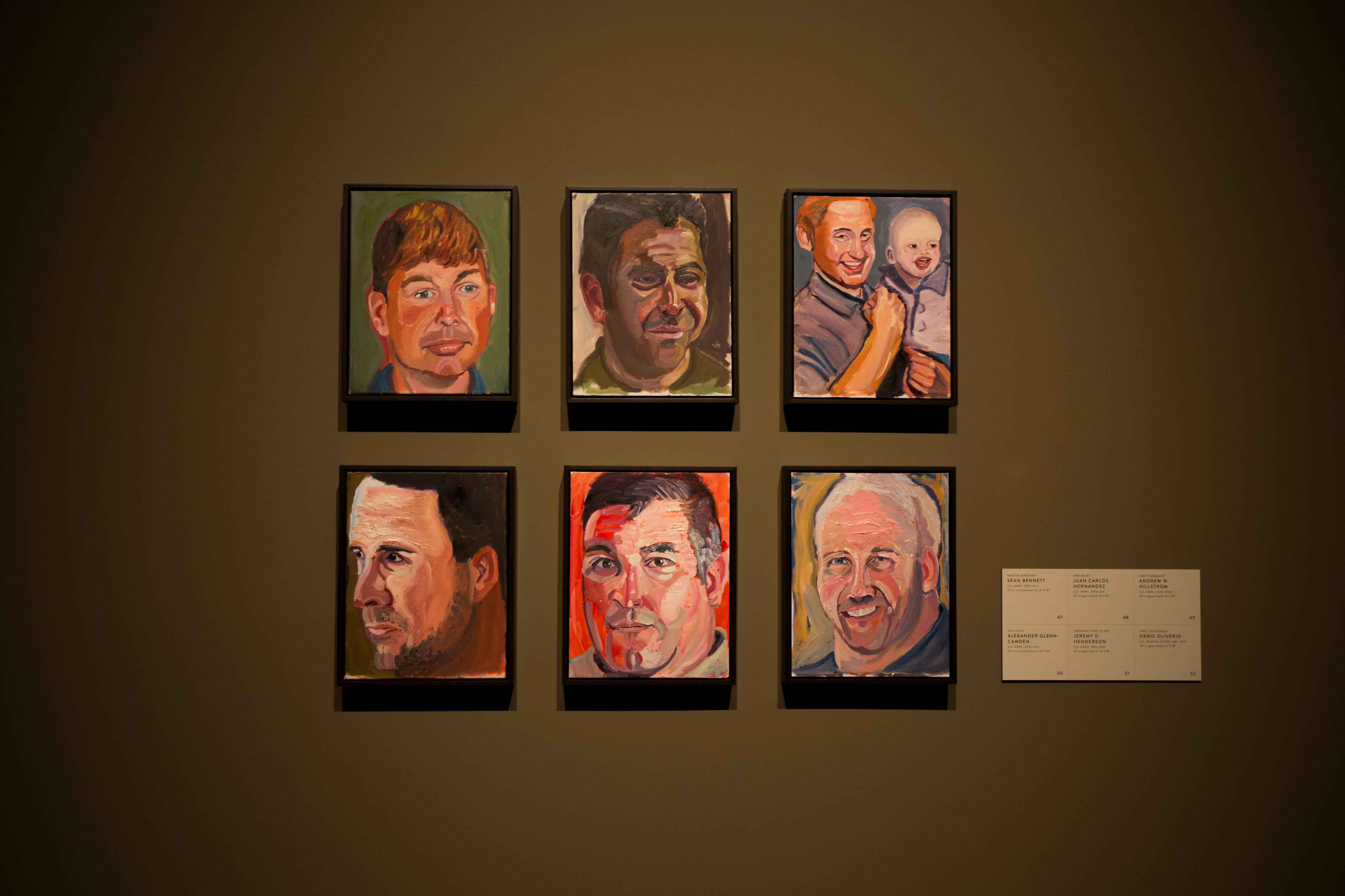 A photo of six individual portraits hanging on the wall, part of the 2017 Portraits of Courage exhibit at the George W Bush Library and Museum.