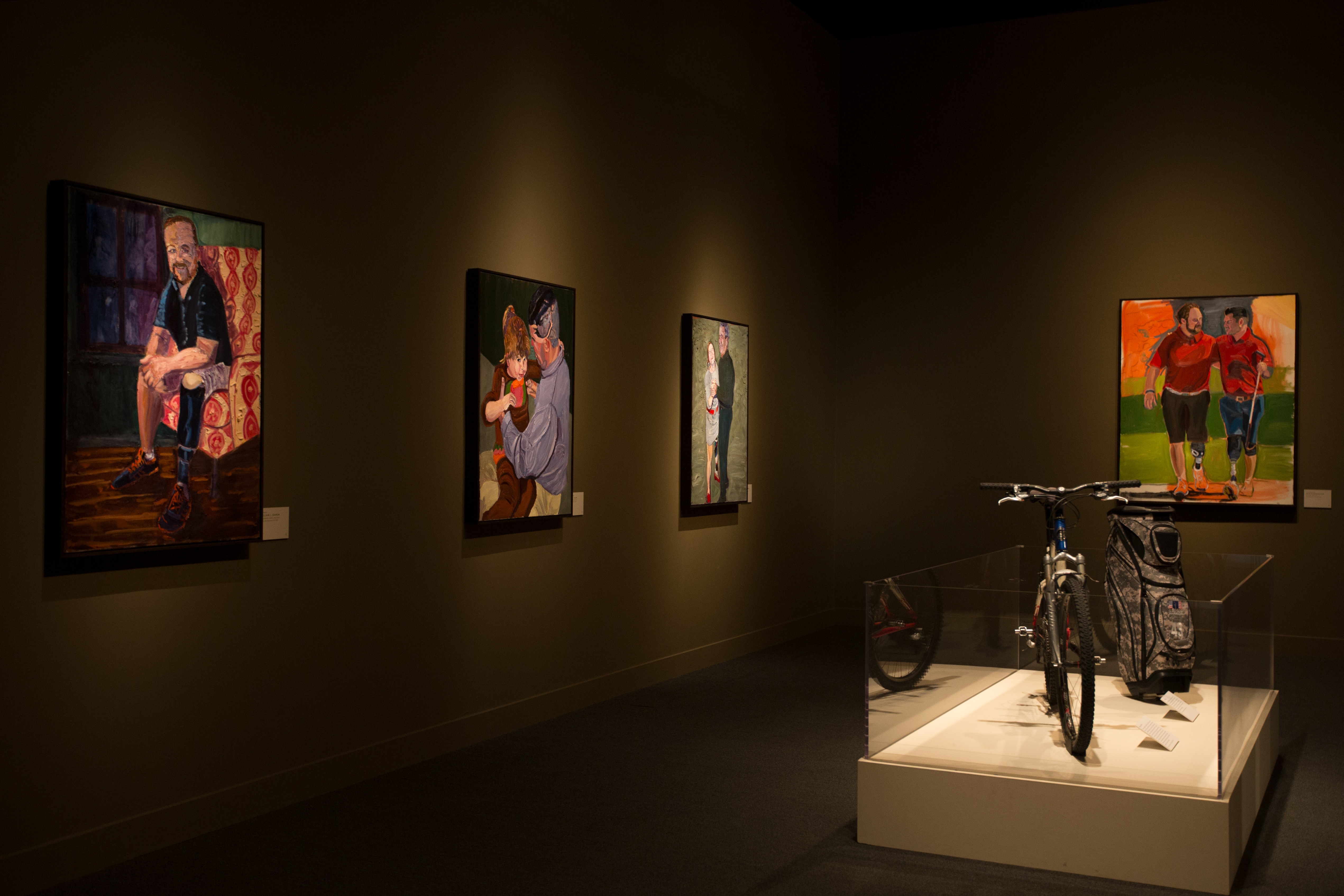 A photo of a room from the 2017 Portraits of Courage exhibit ta the George W Bush Library and Museum.