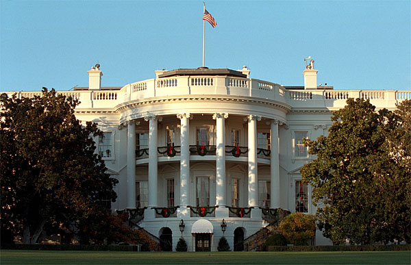Wreaths adorn the windows of the White House as the sun sets on the South Portico, December 1, 2001. 
