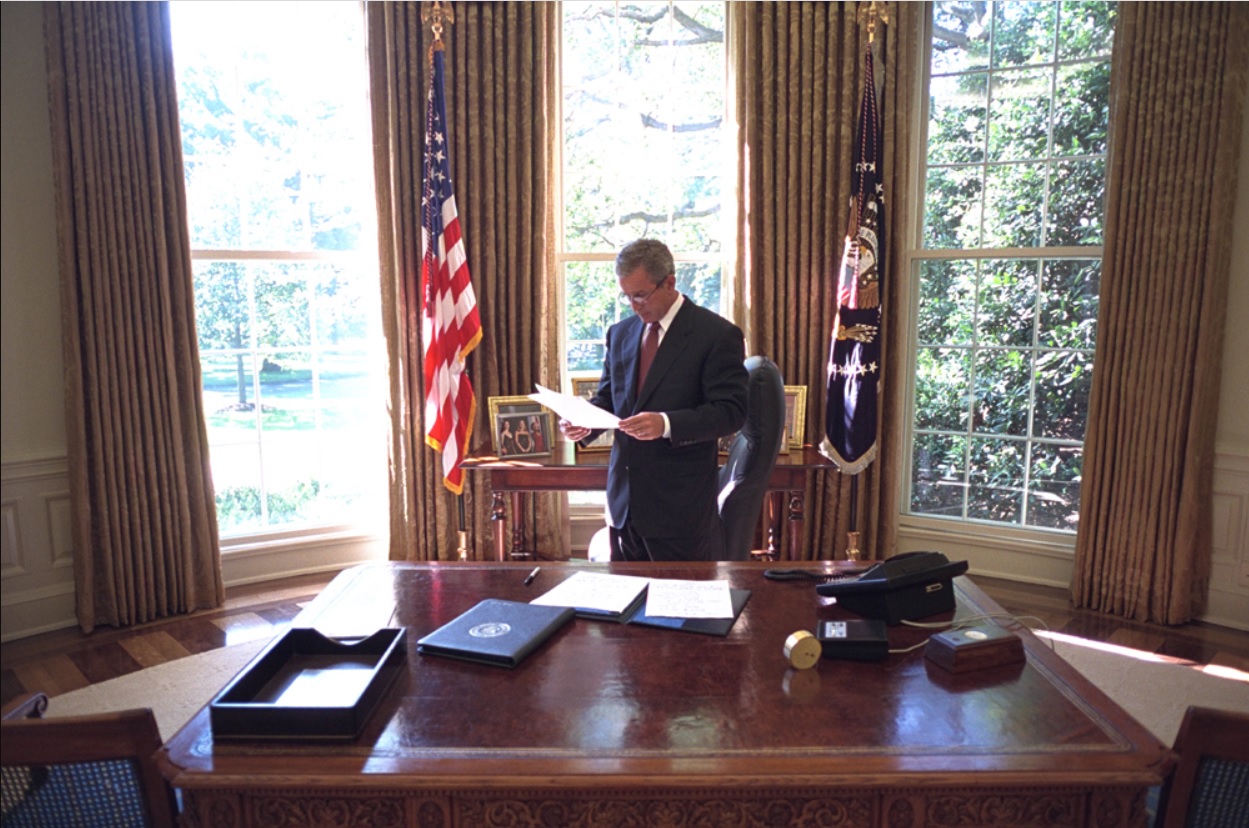 President George W. Bush Reviews a Document in the Oval Office on September 13, 2001.