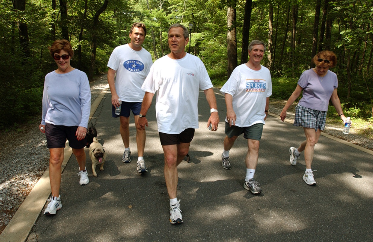 President George W. Bush, First Lady Laura Bush, Marvin Bush, Andy Card and Kathleene Card Walk at Camp David on June 29, 2002.