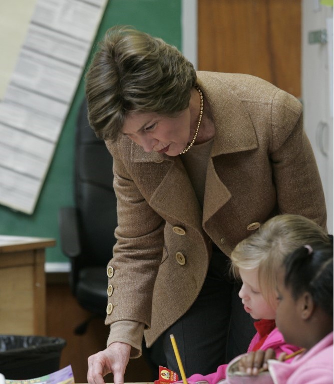 Mrs. Laura Bush works with students at their desks