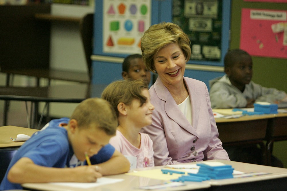 Mrs. Laura Bush sits with students