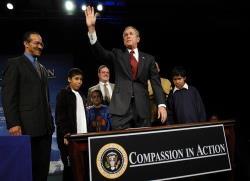 President George W. Bush acknowledges the audience at the White House Regional Conference on Faith-Based and Community Initiatives.