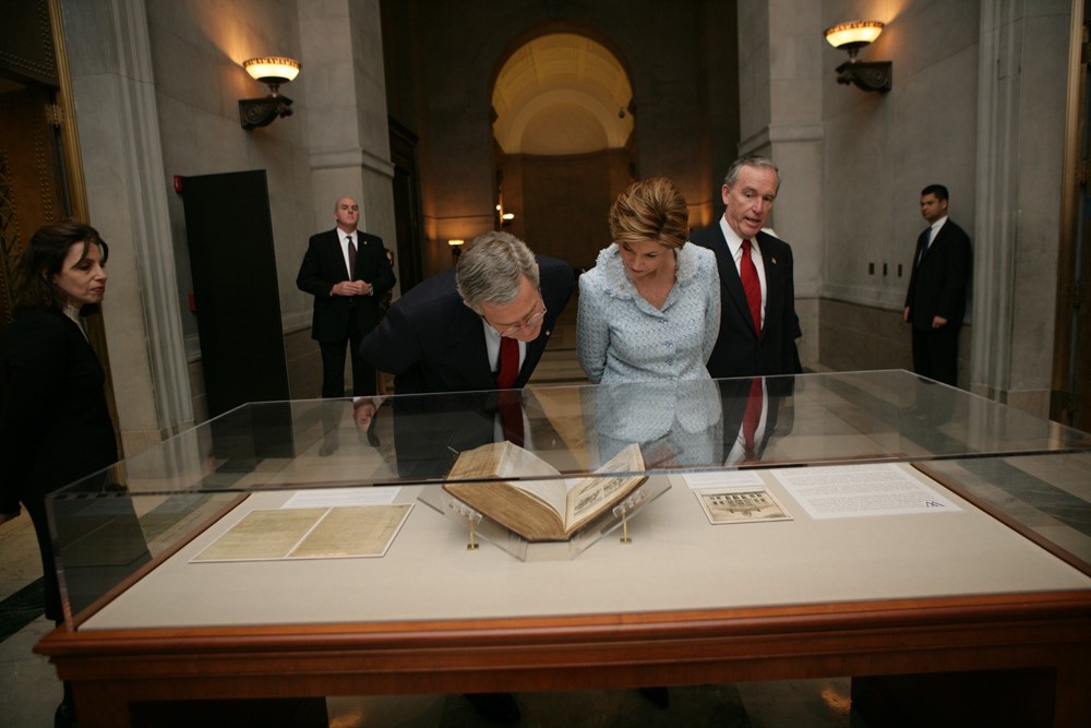 President George W. Bush and Mrs. Laura Bush view a document in a case at the National Archives