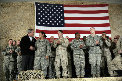 President George W. Bush meets and thanks a group of U.S. and Coalition troops, March 1, 2006, during a visit to Bagram Air Base in Afghanistan, where President Bush thanked the troops for their service in defense of freedom.
