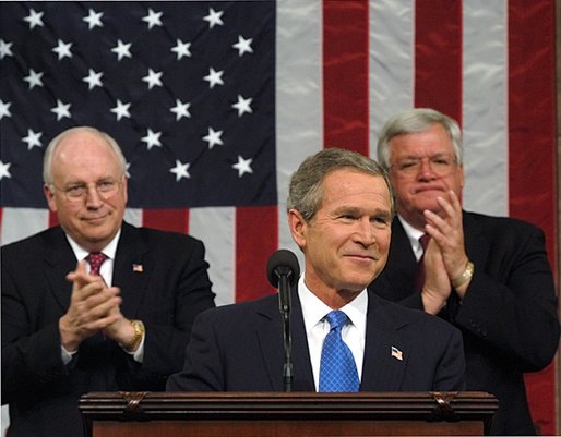 President George W. Bush reacts to applause while delivering the State of the Union address at the U.S. Capitol, January 28, 2003. Also pictured are Vice President Dick Cheney, left, and Speaker of the House Dennis Hastert.