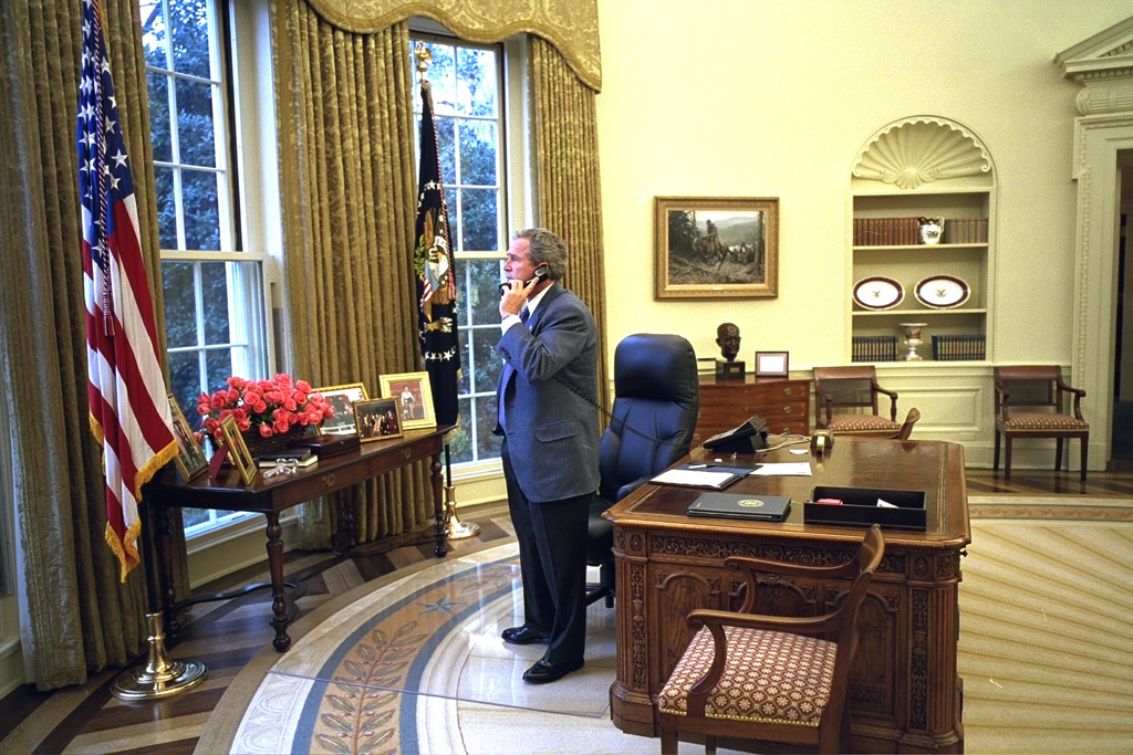 President George W. Bush places calls to the families of the crew of the space shuttle Columbia, February 1, 2003, from the Oval Office of the White House. (P26340-16)