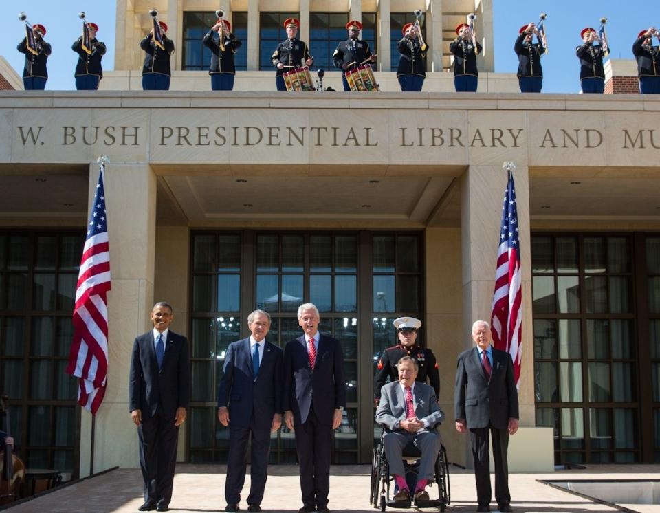 Presidents Jimmy Carter, George H. W. Bush, William J. Clinton, George W. Bush, and Barack Obama stand in front of the George W. Bush Presidential Library and Museum during the 2013 dedication.