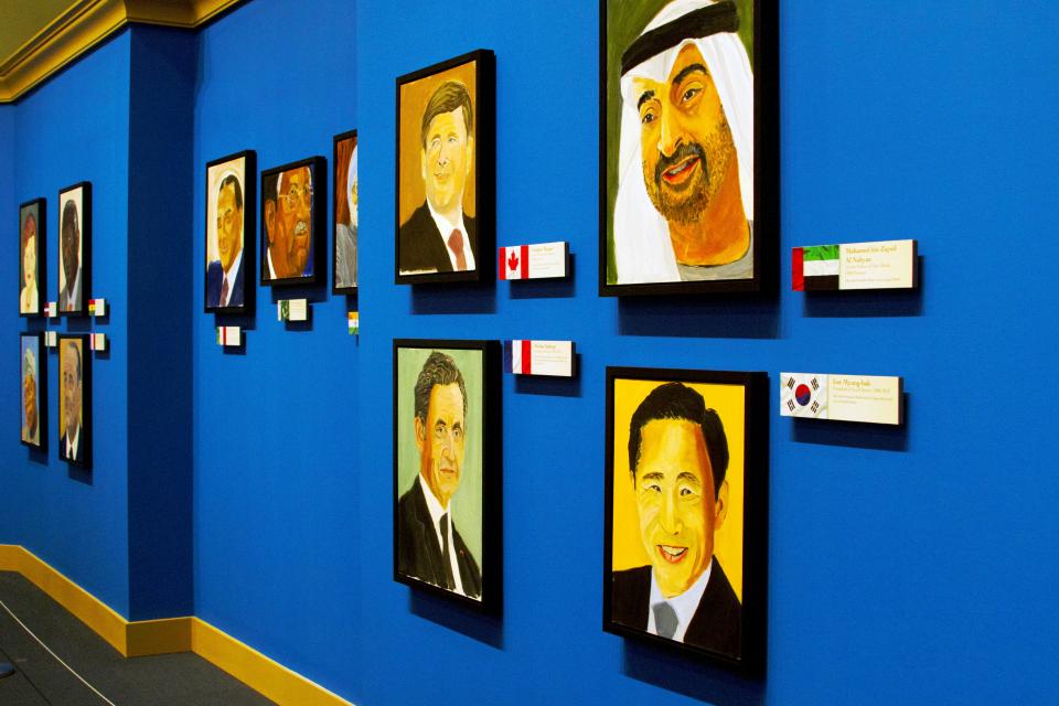 A picture of a wall of painted portraits, part of the 2014 exhibit The Art of Leadership: A President's Personal Diplomacy, at the George W Bush Library and Museum