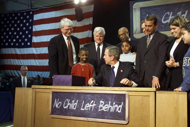 President George W. Bush signs into law the No Child Left Behind Act at Hamilton High School in Hamilton, Ohio.