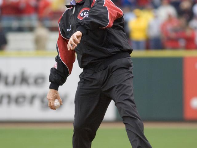 President George W. Bush winds up to throw the first pitch of the 2006 baseball season during the opening game between the Cincinnati Reds and the Chicago Cubs, April 3, 2006, in Cincinnati.  (P040306ED-0535A)