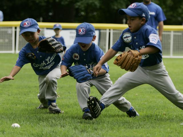 Three little leaguers dive for the ball on the South Lawn of the White House