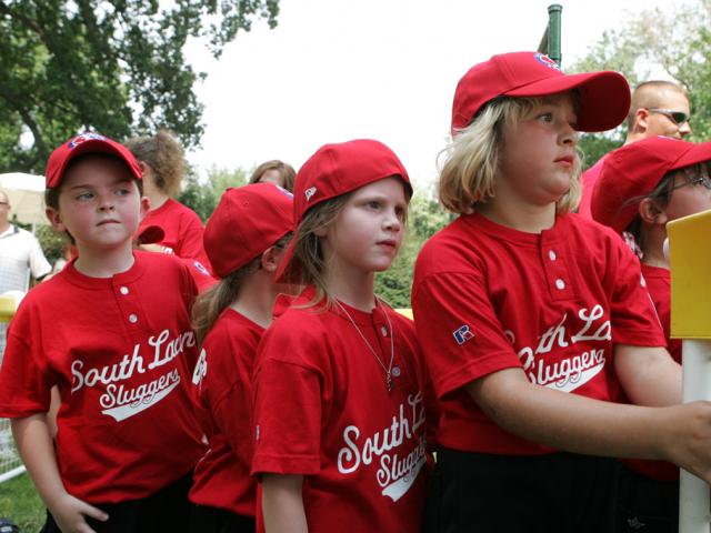 Members of the Luray, Virginia Red Wings watch from the bench.