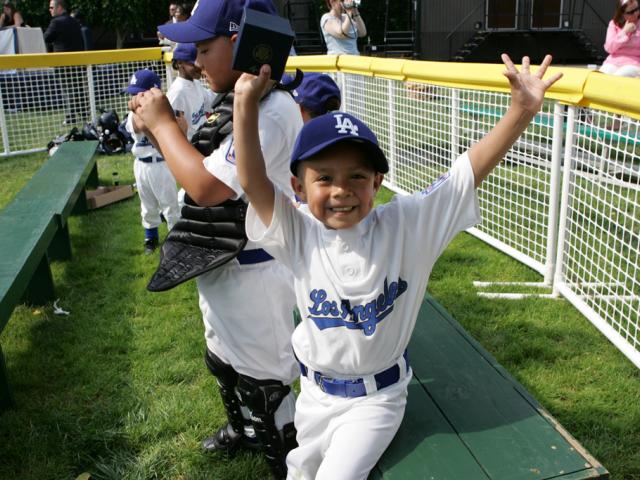 An excited member of the Wrigley Little League Dodgers of Los Angeles shows off his Presidential autographed baseball (P071507JB-0240)