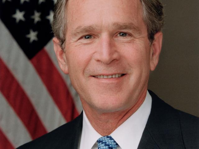 President George W. Bush poses for his official portrait in the Roosevelt Room of the White House, January 14, 2004.  (P25695-23)
