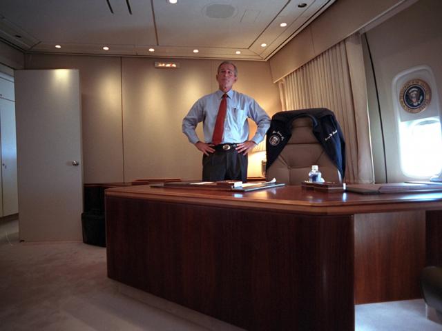 President George W. Bush watches television coverage of the terrorist attacks on the World Trade Center, September 11, 2001, from his office on Air Force One. (P7067-19)