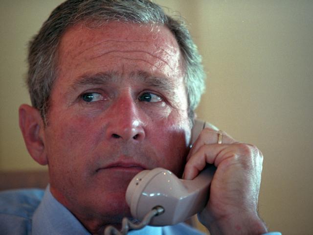 President George W. Bush talks on the telephone with Vice President Dick Cheney and others, September 11, 2001, during the flight from Sarasota, Florida to Barksdale Air Force Base in Louisiana. (P7071-29)